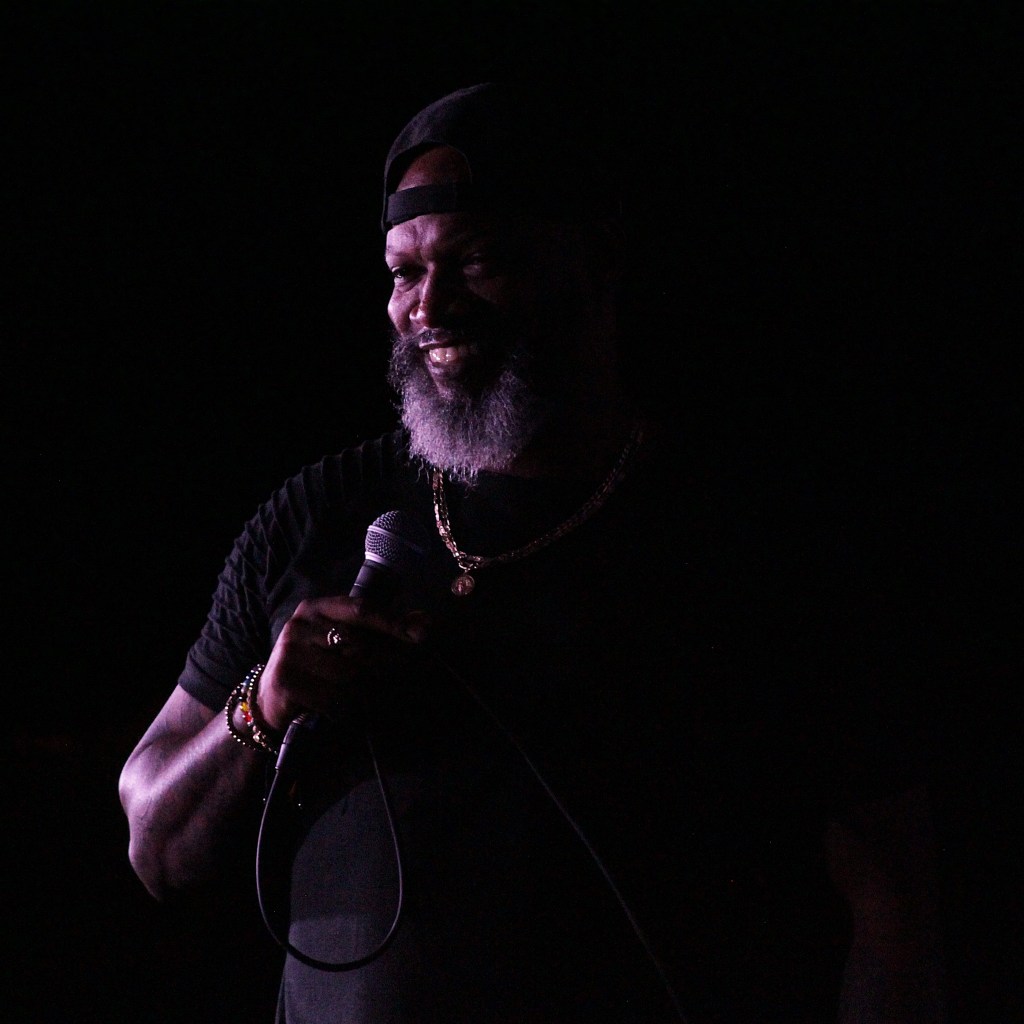Cap City Comedy Club Man Dark Background